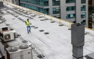 Professional conducts commercial roofing system maintenance inspection
