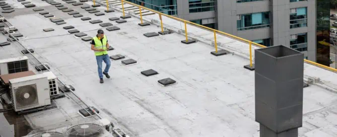 Professional conducts commercial roofing system maintenance inspection