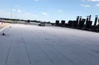 Wide view of Indianapolis flat roof installation with white TPO membrane and HVAC units