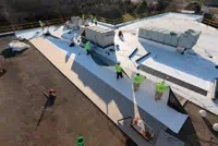 Aerial view of crew installing commercial roof in Dayton, OH