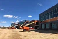 Scissor lifts outside Milwaukee commercial building under construction, clear blue sky