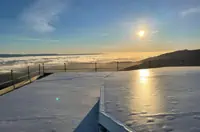 Sunrise over Fresno with Reflective Surface and Low Clouds, Showcasing Industrial Roofing Systems.