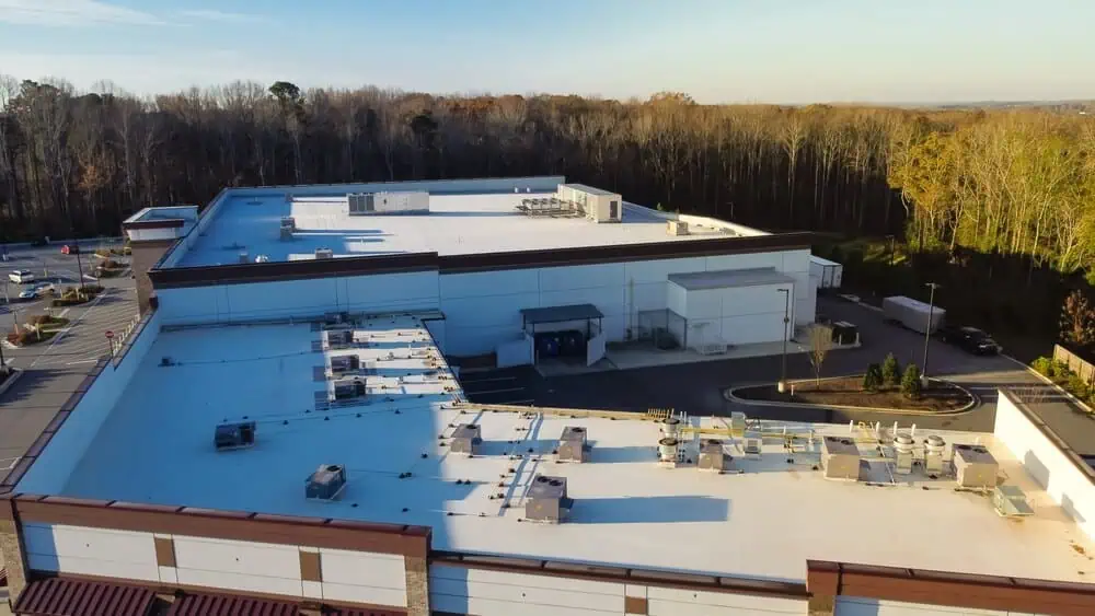 White single-ply roofing membrane on a large commercial building