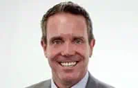 Confident businessman in suit promoting commercial roofing services.