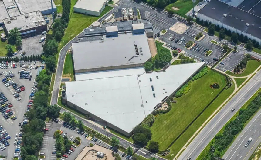 Aerial view of large commercial building with white TPO roof, Byte Grid network