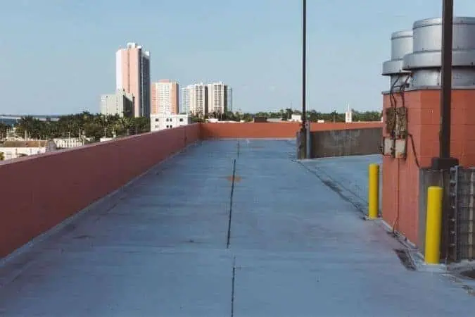 Commercial roof with walkway and skyline in the background