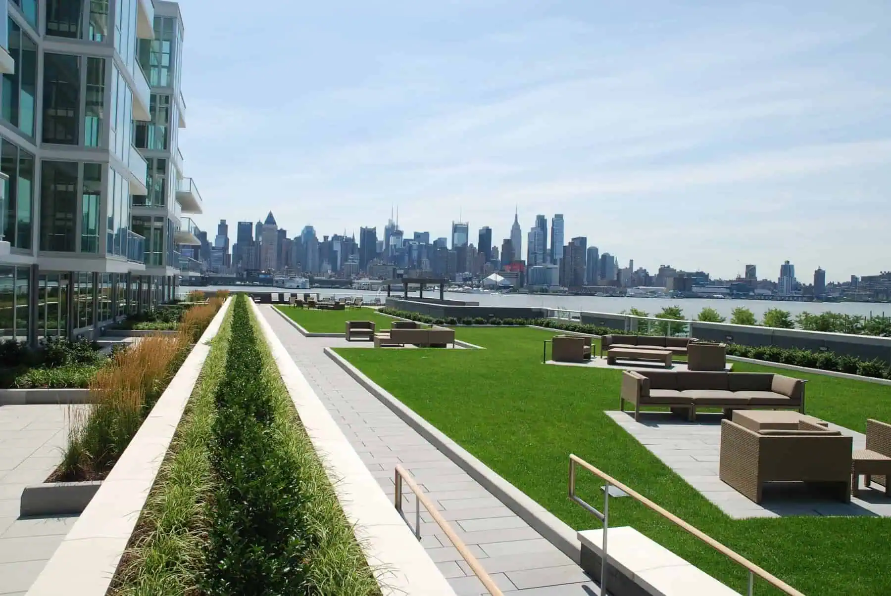 Green roof system with lush lawns on modern rooftop terrace.