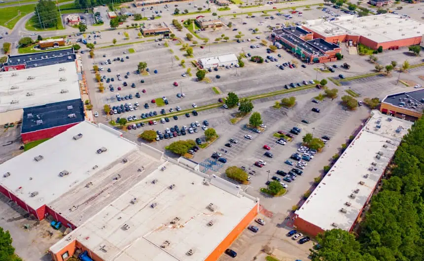 Aerial of Jubilee Square with commercial roofs and parking lot.