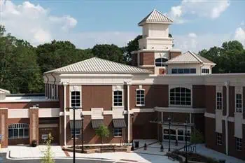 New building with brick siding and new metal roofing freshly installed.