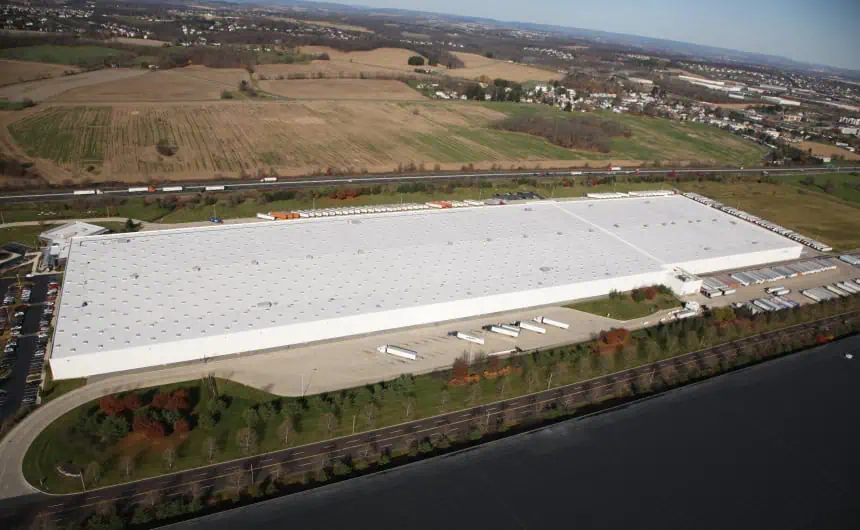 Aerial view of Nestle warehouse with commercial flat roof and numerous trailers.