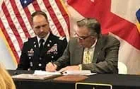 “Official signing ceremony with TPO roofing project agreement”