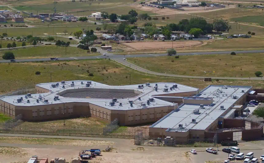 Aerial view of large tan cross-shaped commercial roof in Santa Fe County
