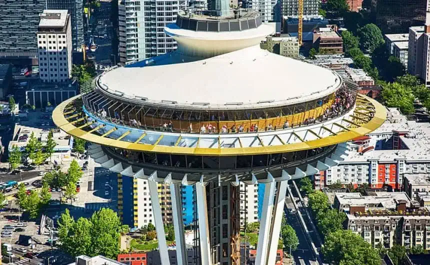 Seattle Space Needle observation deck with people, cityscape backdrop, emphasizing commercial roofing systems.
