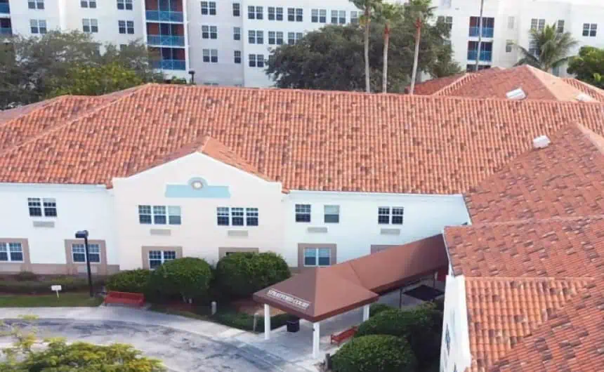 Aerial: Building with red-tiled and flat roofs, Stratfort Court background