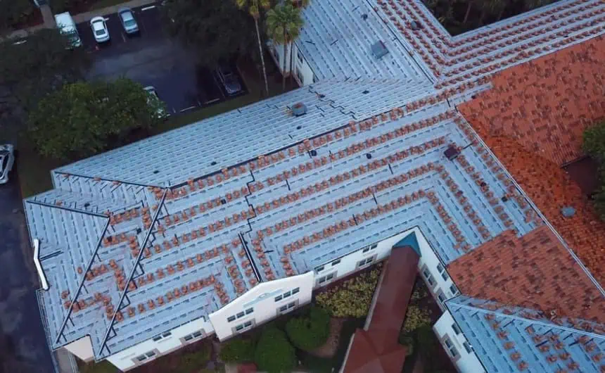 Aerial view of Stratfort Court's complex roof with red tiles and exposed materials.
