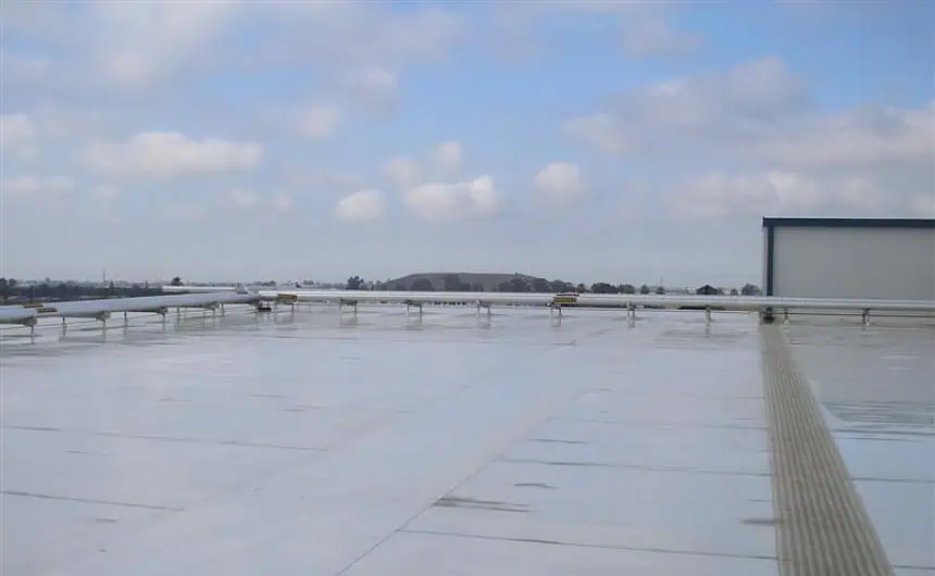 Industrial Flat Roof with Reflective Surface and Secure Railings