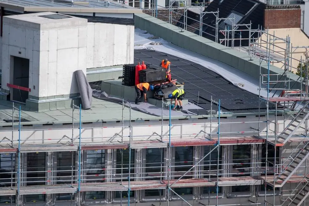 A team of roofing contractors installing a new roofing system.