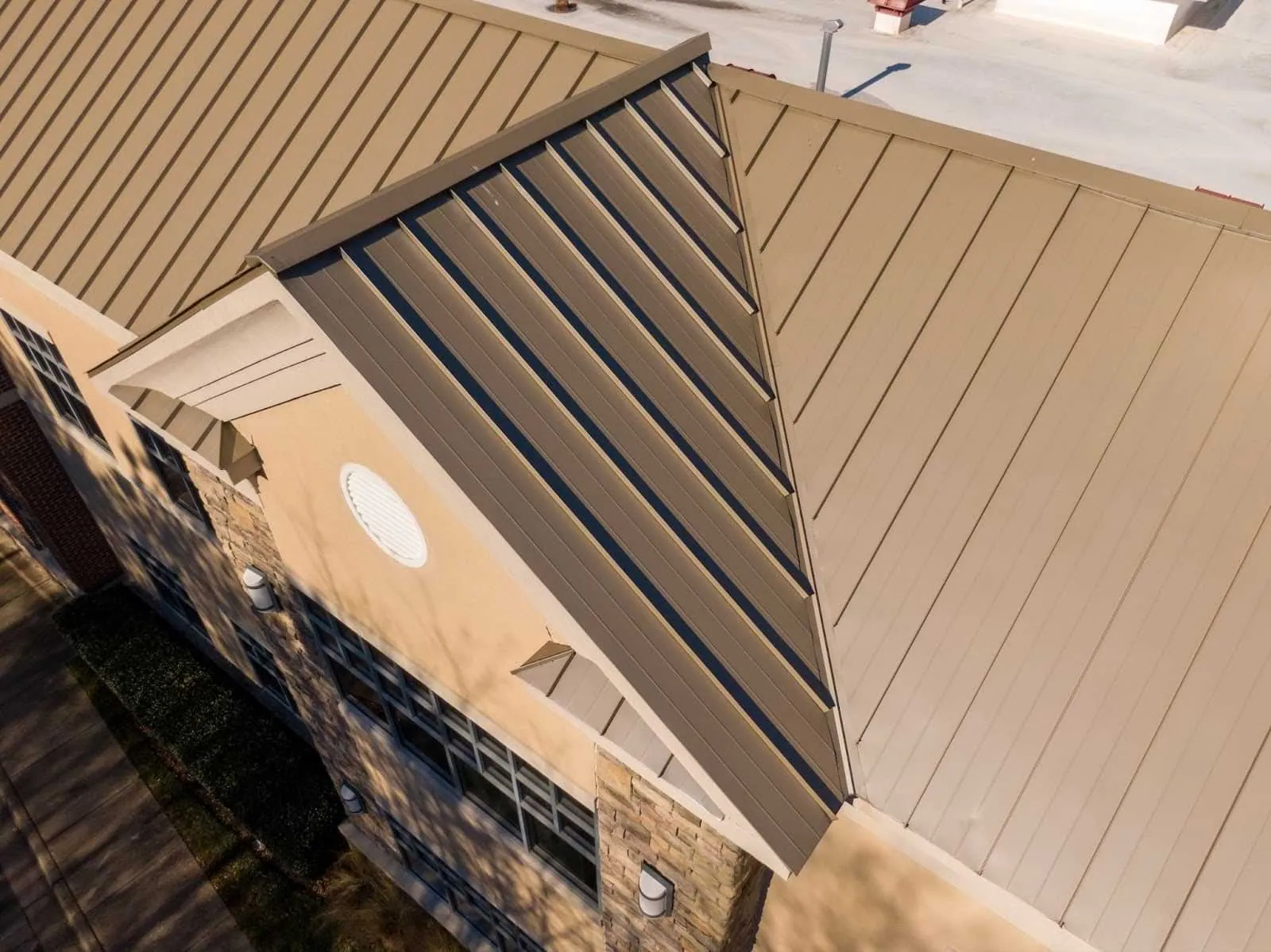 Commercial building with standing seam metal roof on its facade