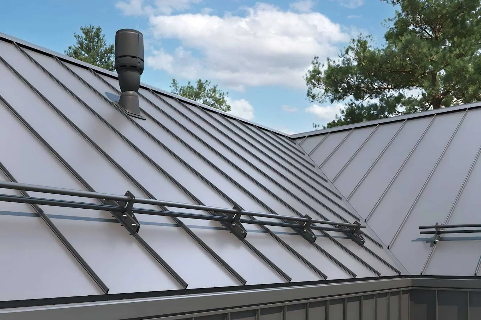 A dark commercial standing seam metal roof with snow retention systems installed